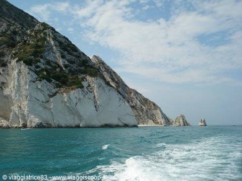 White limestone cliffs over turquoise sea, seen from a moving boat