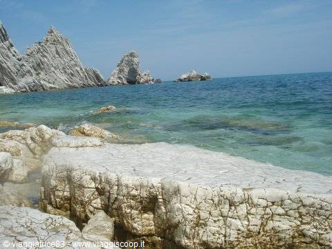 Jagged white rocks over turquoise water at Portovenere