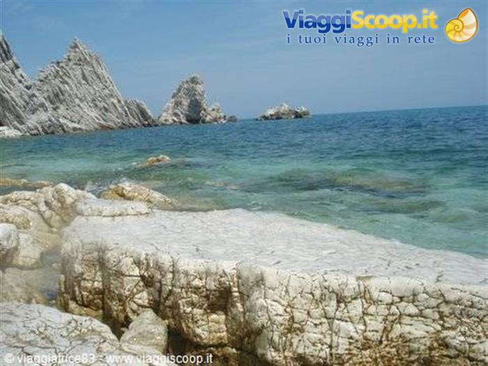 Jagged white rocks over turquoise water at Portovenere