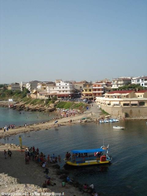 Colorful boats moored near the beach, swimmers and houses overlooking the harbor