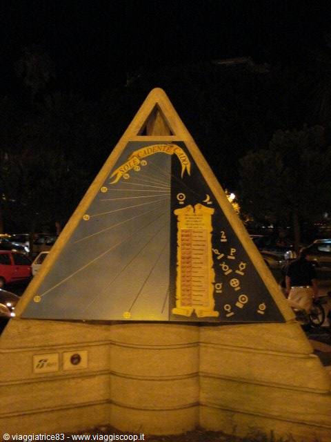 Night-lit sundial sculpture showing sunlight hours chart