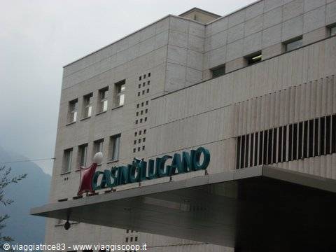 Green Casino Lugano sign on light stone facade, grey sky