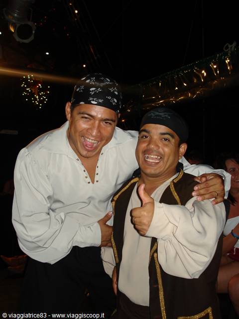 Two smiling entertainers in pirate costumes give thumbs-up during the evening show