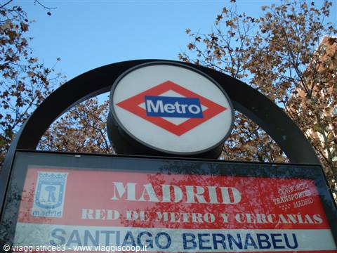 Madrid Metro sign at Santiago Bernabéu station, surrounded by autumn trees