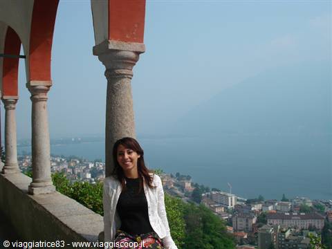 Woman under the orange arcades of Madonna del Sasso sanctuary, overlooking Lake Maggiore