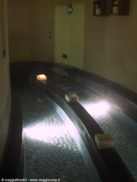 Indoor thermal pools with floating candles and soft lighting