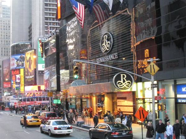 Yellow taxis and crowds under glowing billboards of the Renaissance hotel, Times Square
