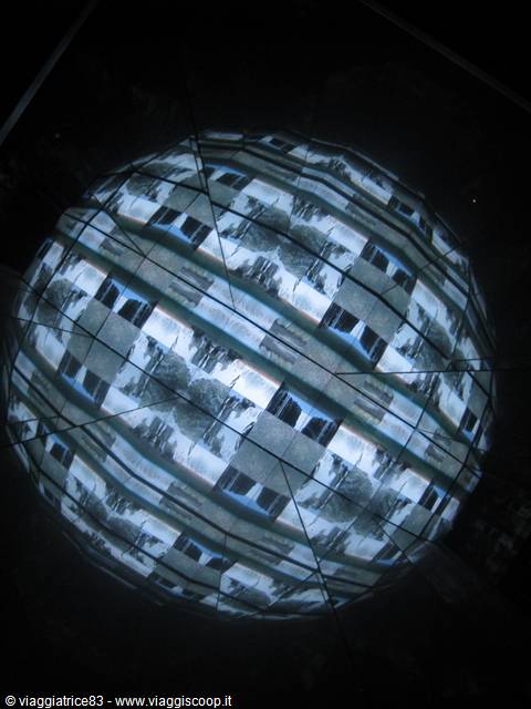 Glowing sphere with checkered video projections in the dark
