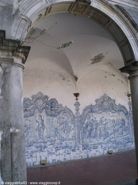 Stone arch framing a wall of blue and white azulejo tiles