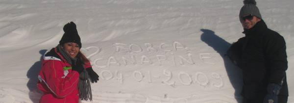 Woman and man beside snow writing Forca Canapine 2009