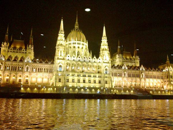 Budapest Parliament illuminated at night reflecting on the Danube