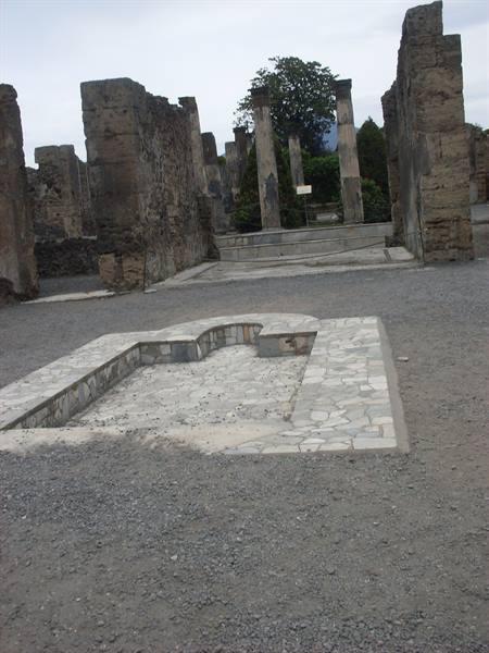Marble-lined pool among columns and ancient walls in Pompeii