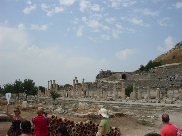 Tourists among columns and clay pipes at ancient Ephesus ruins