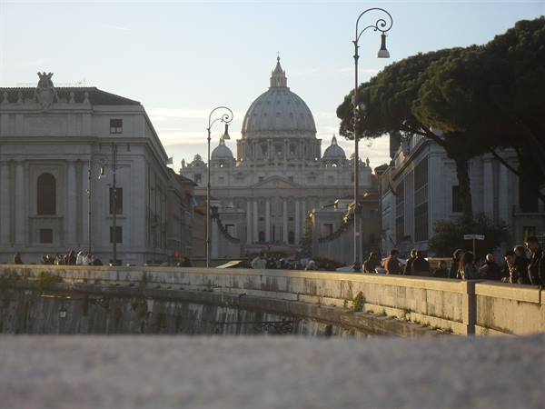 Tourists along Via della Conciliazione with St. Peter's dome in the background