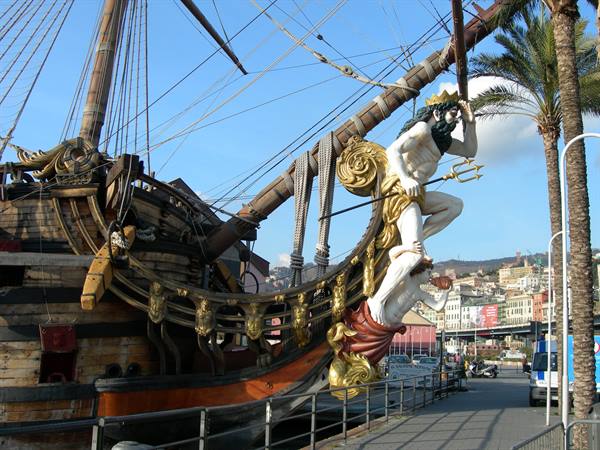 Neptune statue with trident on a galleon's bow at Genoa harbor