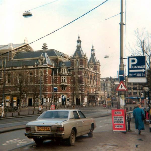 Car parked near Amsterdam's Stadsschouwburg theatre, signs and pedestrian