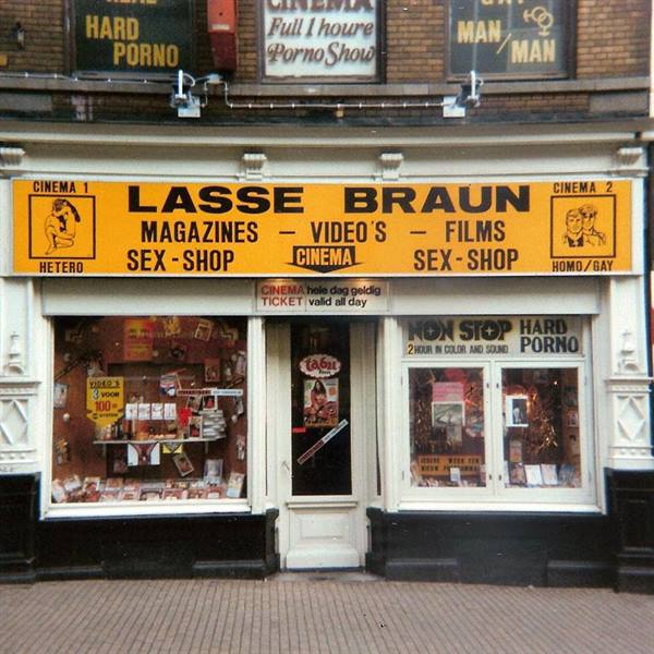 Lasse Braun sex-shop storefront with yellow signs and magazine-filled windows