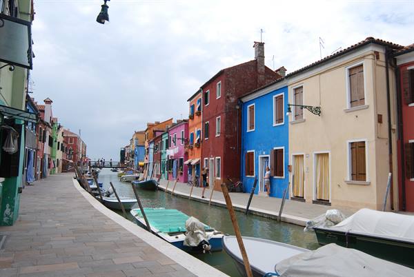 Burano: colorful houses along the canal, moored boats, soft light