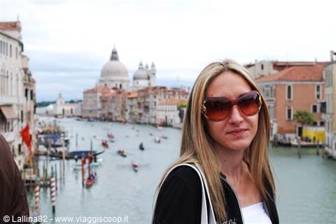 Woman with sunglasses in front of the Grand Canal and Santa Maria della Salute in Venice
