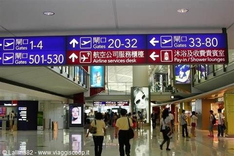 Blue gate signs and duty-free shop inside Hong Kong International Airport