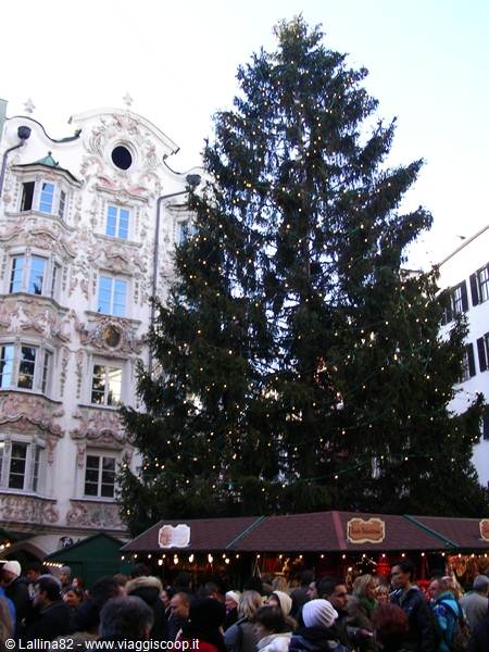 Illuminated Christmas tree and market stalls by the Helblinghaus in Innsbruck