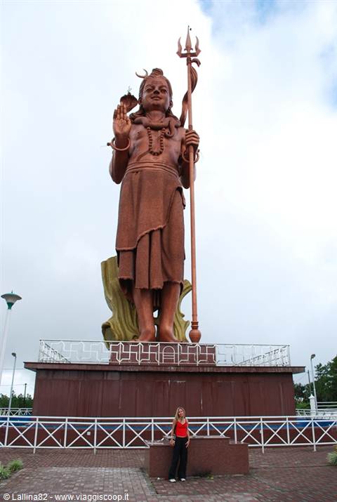 Tourist beside the giant Shiva statue holding a trident, Grand Bassin