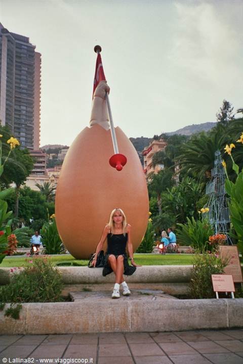 Woman sitting in front of the giant egg sculpture in Monte-Carlo Casino gardens