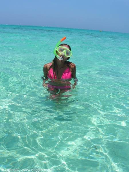 Woman with snorkel mask in clear turquoise water