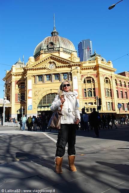 Tourist in front of Flinders Street Station, yellow facade and dome