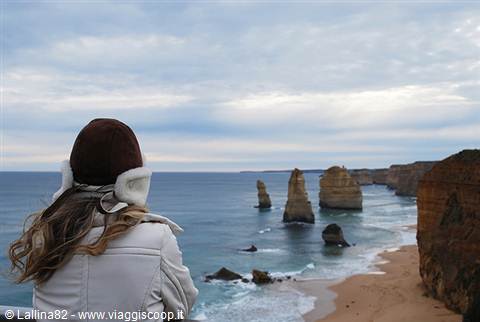 Woman in ushanka hat gazes at the Twelve Apostles, Great Ocean Road, Australia