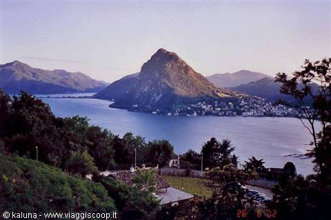 Monte San Salvatore rising above Lake Lugano among trees and villas