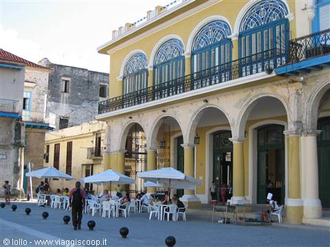 Plaza Vieja, Havana: yellow colonial building with arches and wrought-iron balconies