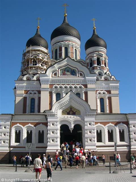 Alexander Nevsky Orthodox Cathedral in Tallinn, black domes, tourists on the steps in sunlight