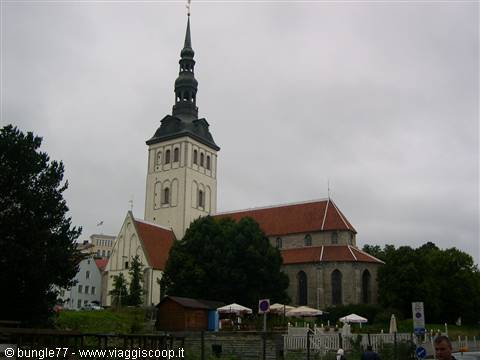 St. Nicholas' Church in Tallinn, white tower and red roof under grey sky