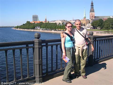 Tourist couple on a bridge over the Daugava river in Riga