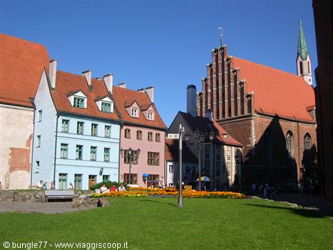 Colorful gabled houses and St. John's brick church in Riga