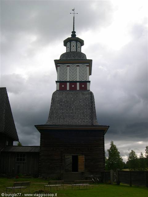 Wooden bell tower of Petäjävesi Old Church under cloudy sky