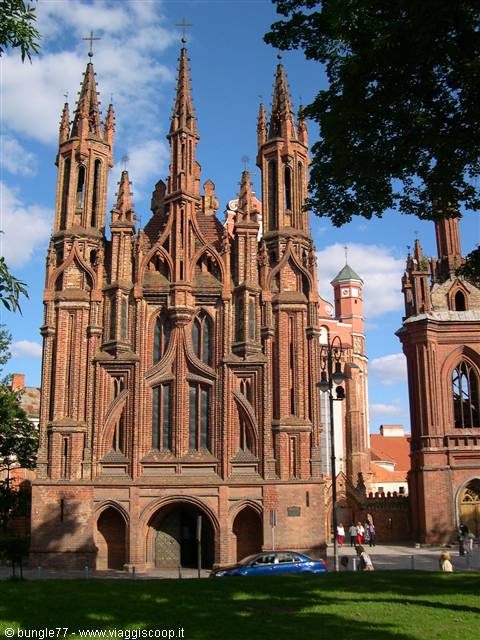 St. Anne's Church in Vilnius, red brick Gothic spires under blue sky