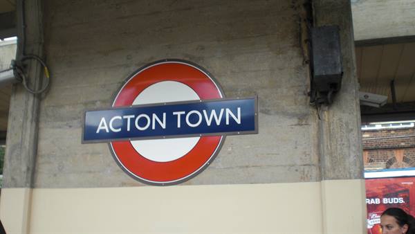 Acton Town tube roundel sign mounted on a concrete wall