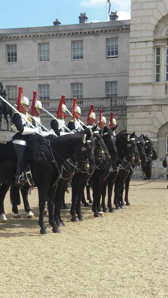 Mounted guardsmen in red helmets on black horses, Horse Guards Parade, London