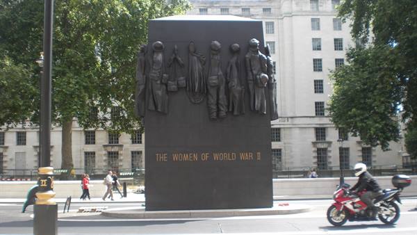 Bronze monument to the women of World War II, London, motorbike passing by