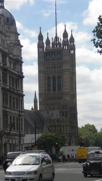 The Victoria Tower of the Palace of Westminster rises above London traffic