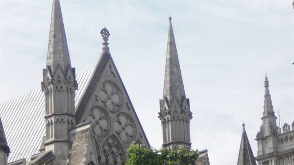Gothic stone spires with carved rose windows of Westminster Abbey