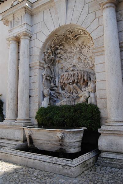 Marble fountain with carved relief and sculpted basin at Villa d'Este, Tivoli