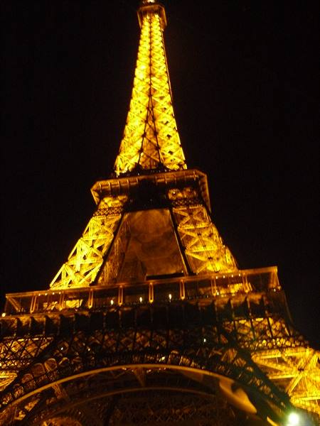 Eiffel Tower glowing golden against the dark night sky