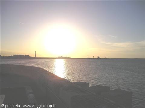 sunset over the sea and in the background the new lighthouse