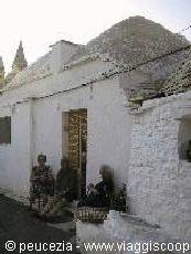 women at the entrance of a trullo
