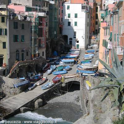 Riomaggiore: colorful fishing boats dry-docked among village houses