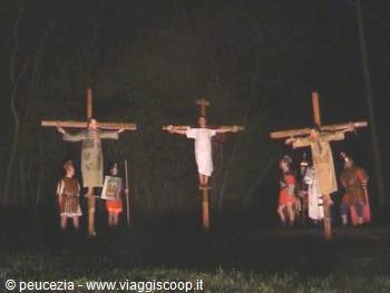 Night reenactment of the crucifixion with costumed actors on three wooden crosses
