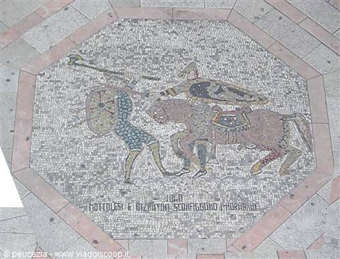 Octagonal street mosaic: mounted knight with lance attacking a shield-bearing soldier